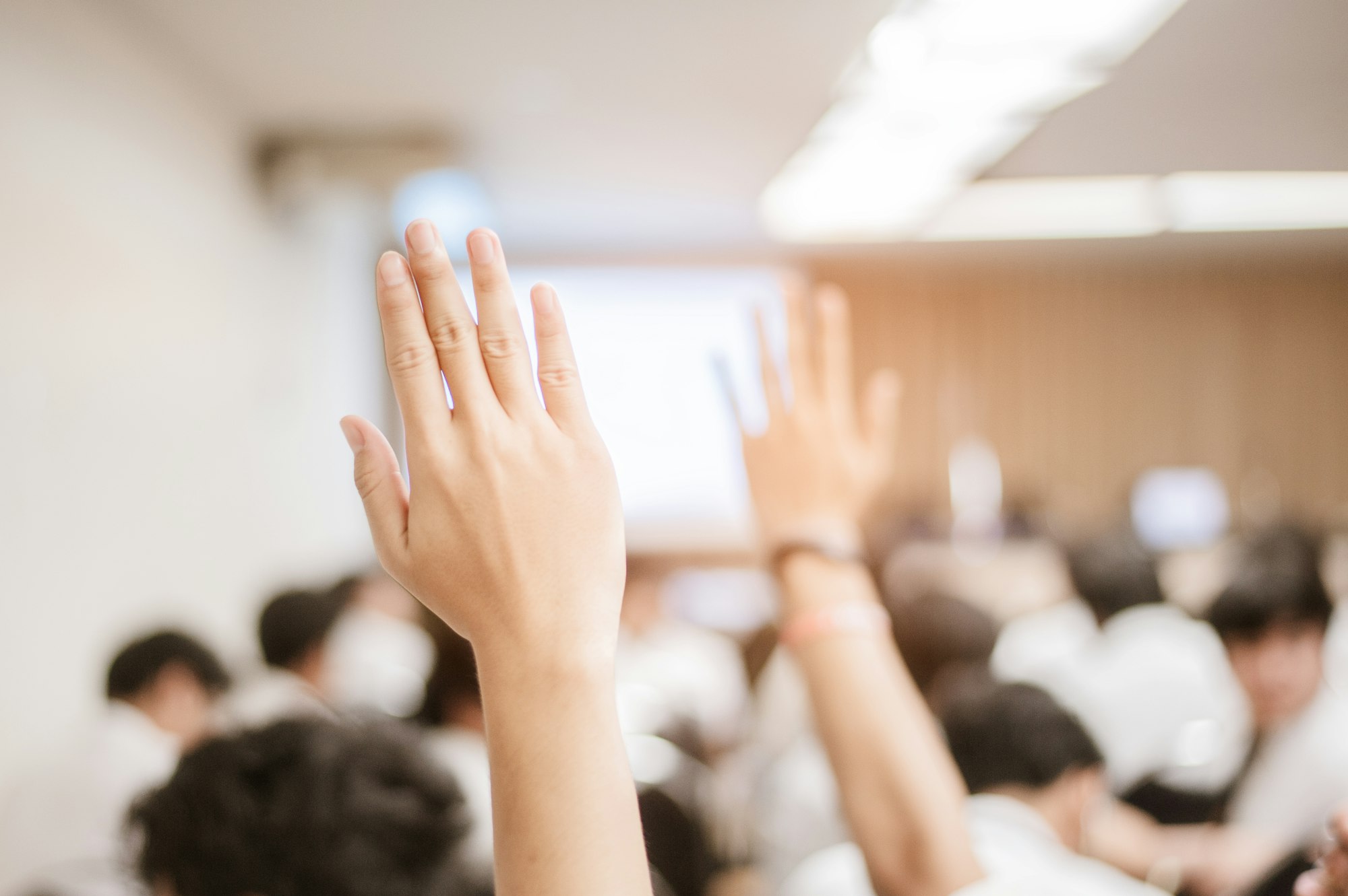 businessman raising hand during seminar. Businessman Raising Hand Up at a Conference to answer a que